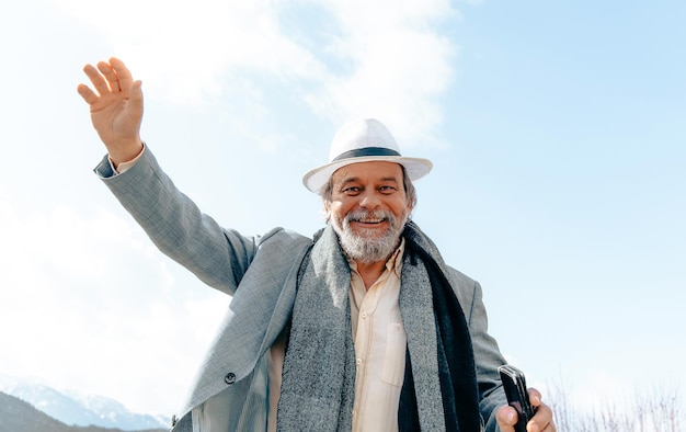 Portrait of a confident handsome mature man pensioner grandfather in the small town