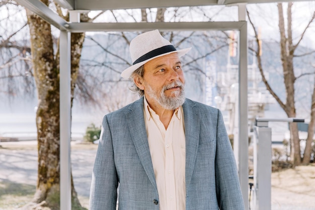 Portrait of a confident handsome mature man pensioner grandfather in the small town