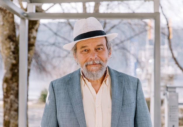 Portrait of a confident handsome mature man pensioner grandfather in the small town