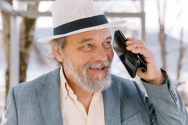 Portrait of a confident handsome mature man pensioner grandfather in the small town