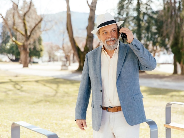 Portrait of a confident handsome mature man pensioner grandfather in the small town