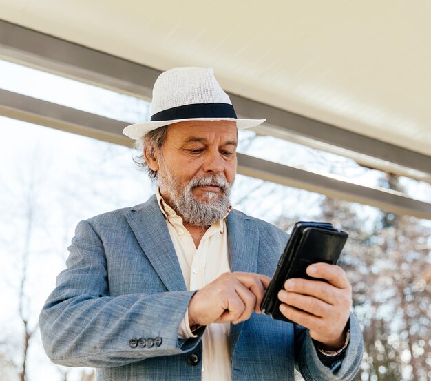 Portrait of a confident handsome mature man pensioner grandfather in the small town