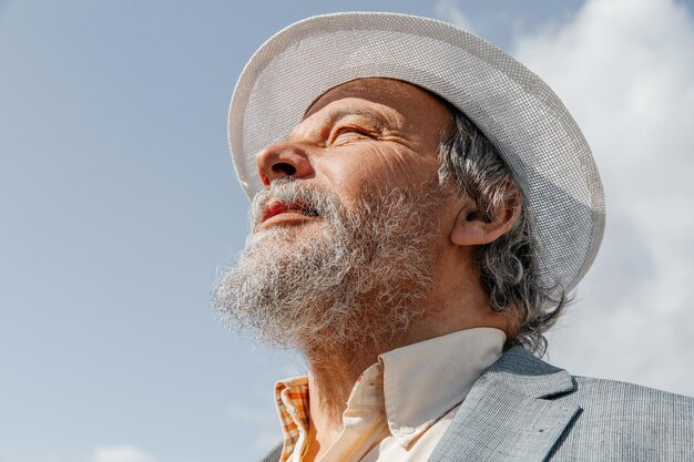 Portrait of a confident handsome mature man pensioner grandfather in the small town