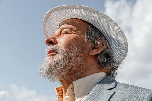 Portrait of a confident handsome mature man pensioner grandfather in the small town