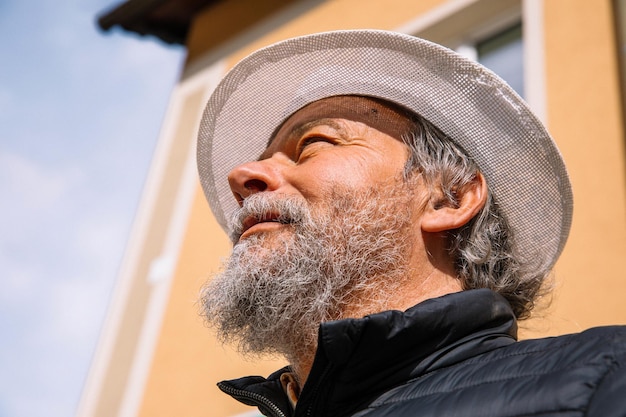 Portrait of a confident handsome mature man pensioner grandfather in the small town