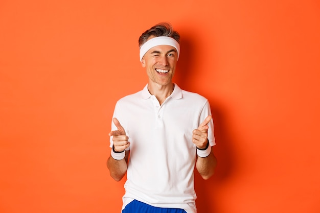 Portrait of confident, handsome middle aged man in workout uniform