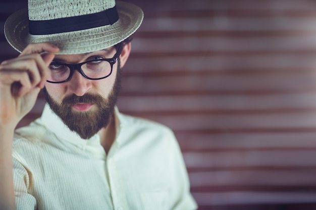 Portrait of confident hipster wearing eyeglasses and hat