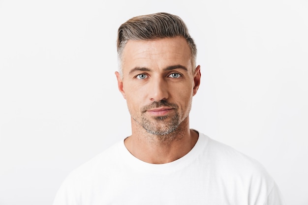 Portrait of confident man 30s with bristle wearing casual t-shirt posing isolated on white