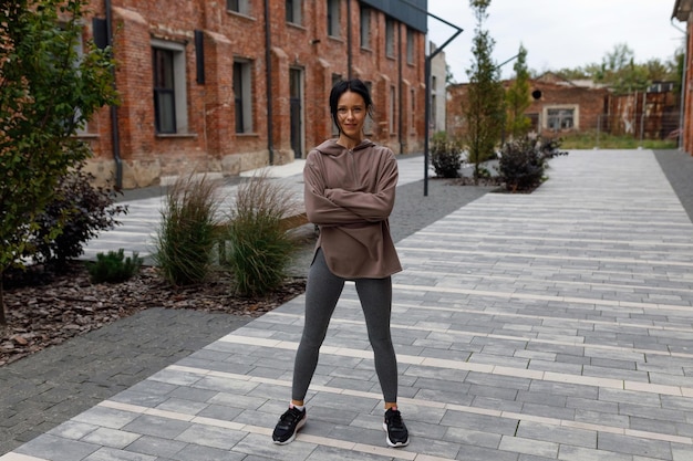 Portrait of a confident sports woman standing on the city street