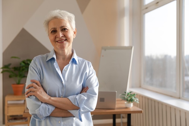 Portrait of confident stylish european middle aged senior woman at workplace stylish older mature s