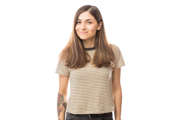 Portrait of confident woman standing against white background