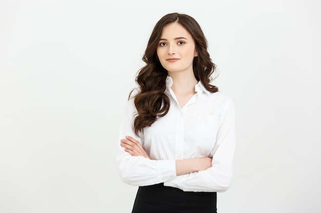 Portrait confident young businesswoman keeping arms crossed and looking at camera