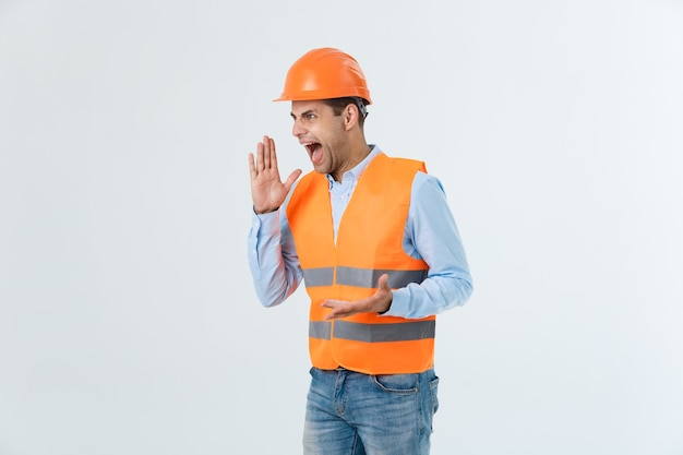 Portrait of confused male designer or architect, feels stressed, being nervous, keeps hand on head, stares in blueprint. Exhausted man creates construction project alone, has some troubles.