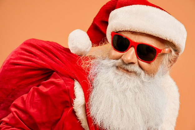 Portrait of cool Santa Claus wearing trendy sunglasses