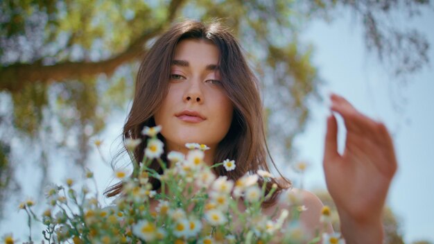 Portrait countryside model hold flowers in rural nature woman camomiles bouquet