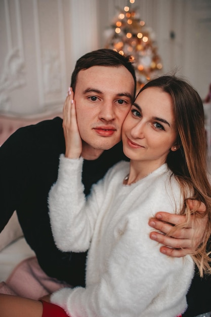 portrait of a couple on the background of Christmas decorations