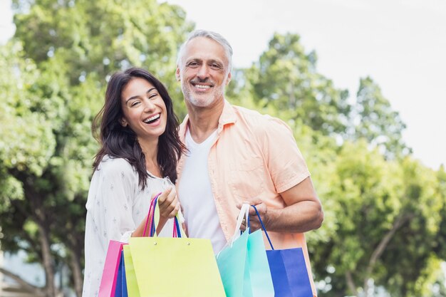 Portrait of couple enjoying with shopping bags