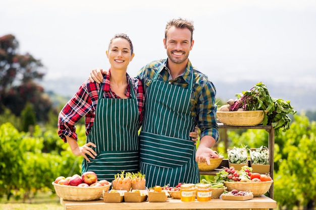 Portrait of couple selling vegetables