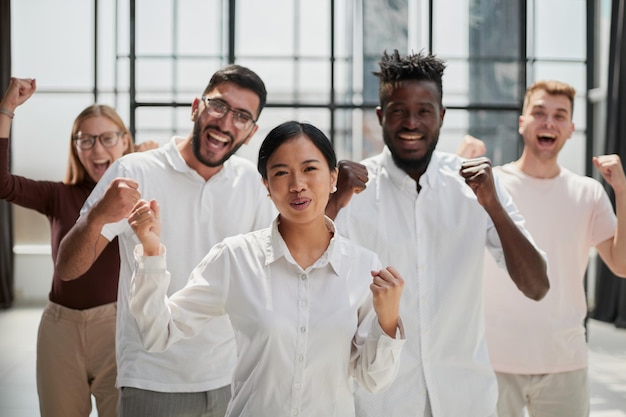 Portrait of creative business team standing together and laughing multiracial business people togeth