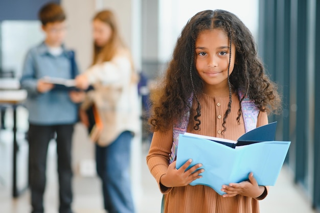 Portrait of cute AfricanAmerican girl at school