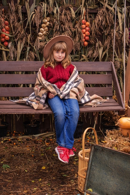 portrait of a cute girl in autumn near the house