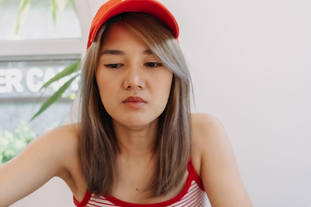 Portrait of cute girl in red wearing red hat