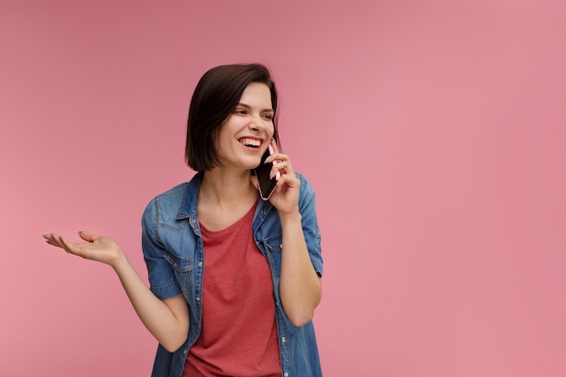 Portrait of cute happy brunette woman wearing t-shirt and jeans shirt