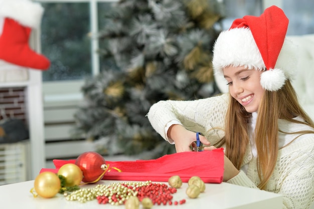 Portrait of cute happy teen girl preparing for Christmas