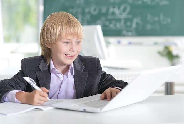 Portrait of a cute little boy using laptop