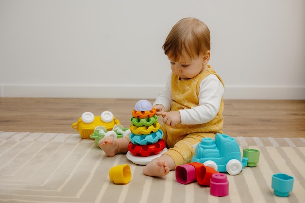 Portrait of a cute little child playing with a colorful pyramid