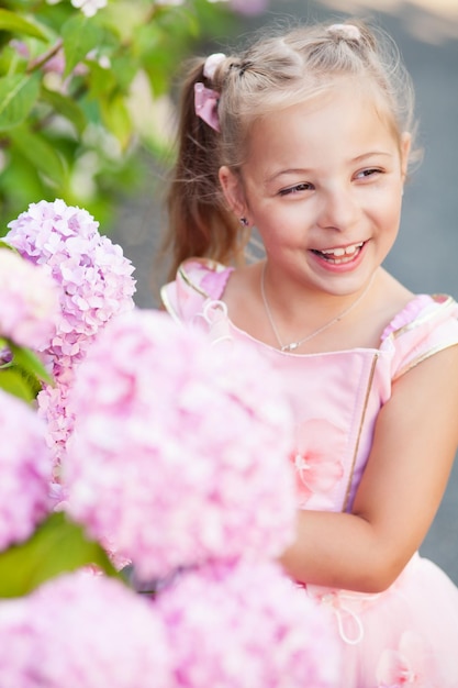 Portrait of a cute little girl wearing eyeglasses and dress.