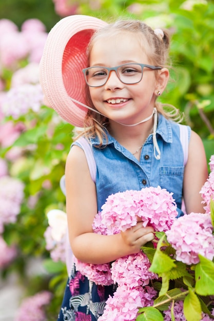 Portrait of a cute little girl wearing eyeglasses and dress.