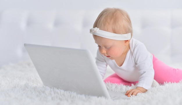 Portrait of a cute little girl with a laptop