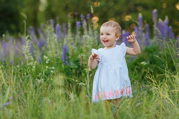 Portrait of cute, one year old girl in blue dress