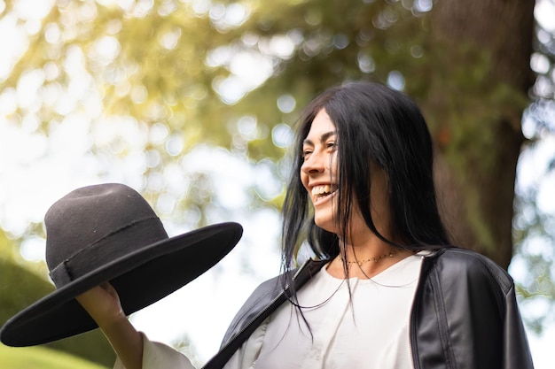 Portrait of cute smiling girl in hat outdoors Close up of young woman in hat smiling at camera on grass Face of smiling girl in hat on the grass