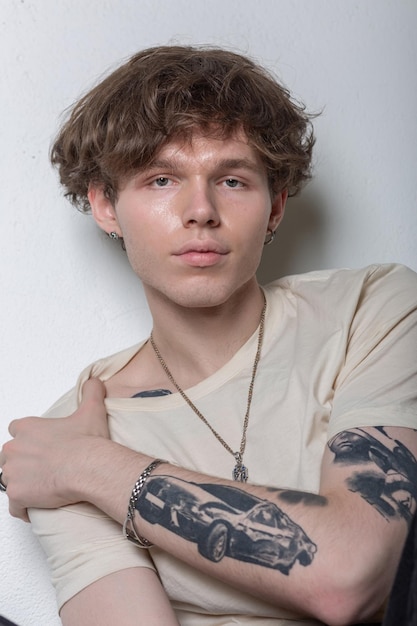 Portrait of a cute tattooed youngster on the white background