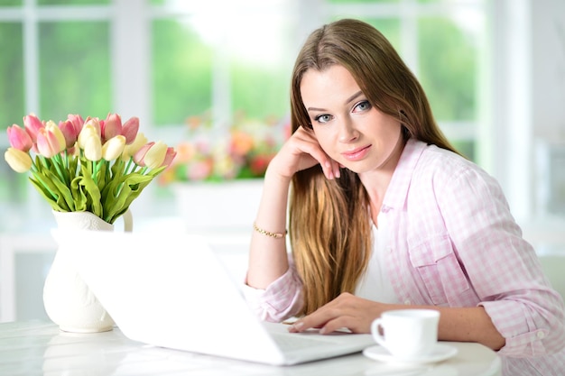 Portrait of cute young businesswoman working at desk