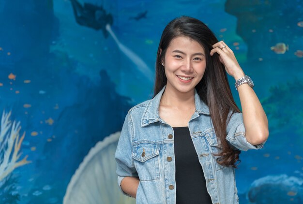 portrait of cute young student in jacket jeans smile on under water background