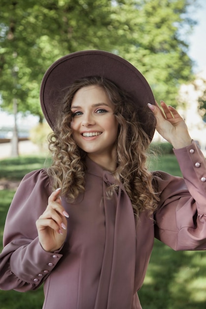 Portrait cute young woman in French style in park outdoors