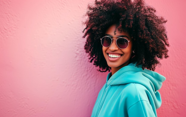 Portrait of dark skinned woman wearing sunglasses and smiling while isolated over purple background