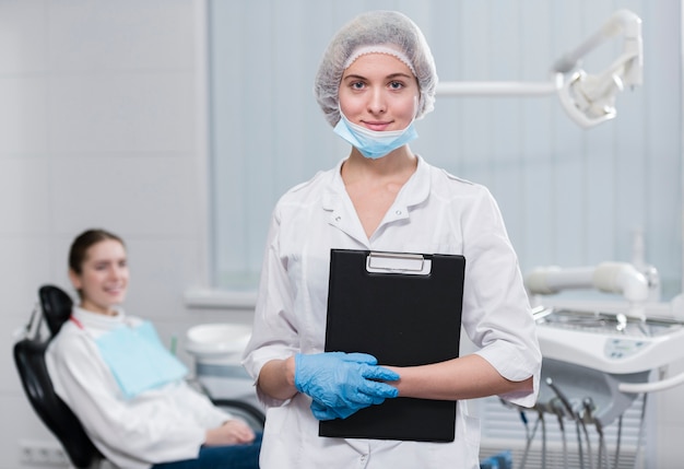 Portrait of dentist holding a clipboard