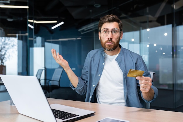 Portrait of disappointed and deceived businessman inside office mature man looking at camera