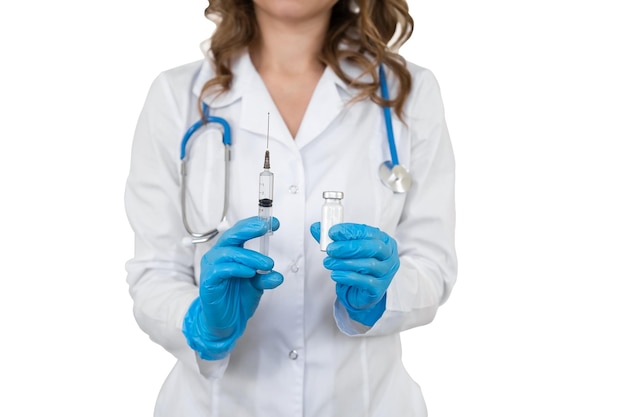 Portrait of a doctor in a bathrobe with a stethoscope The girl holds a medical syringe in her hands