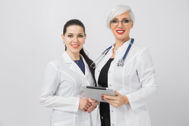 Portrait of Doctor and nurse with tablet in hands isolated on white background