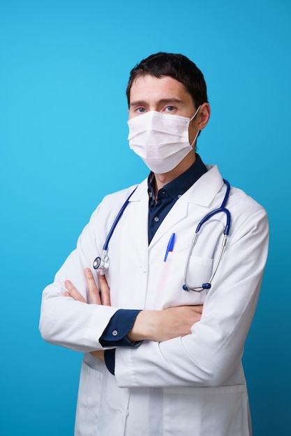 Portrait of a doctor with a stethoscope on the neck and mask on his face