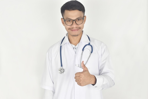 Portrait of doctor with stethoscope and showing thumbs up medical coverage insurance concept