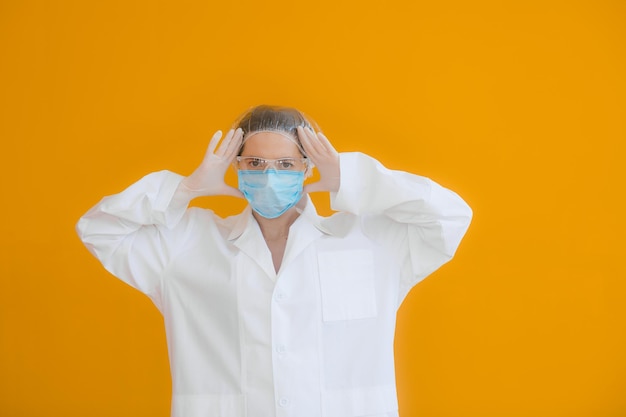 Portrait of a doctor a young woman in a protective medical mask on her face