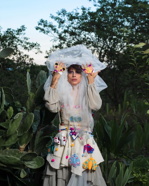 Portrait of a drag queen in a rural scenery Nonbinary gender person interacting with nature