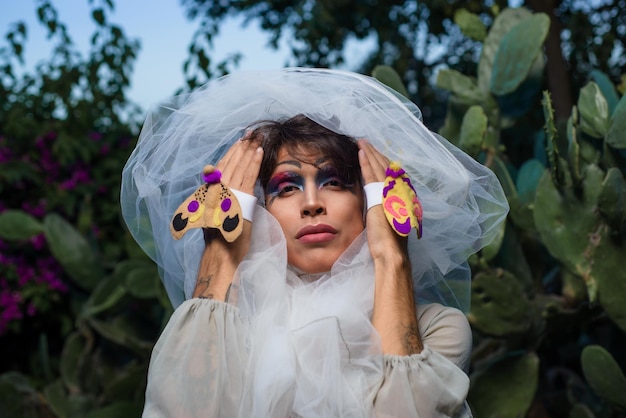 Portrait of a drag queen in a rural scenery Nonbinary gender person interacting with nature