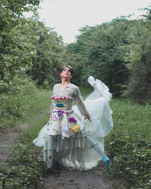 Portrait of a drag queen in a rural scenery Nonbinary gender person interacting with nature